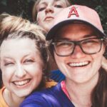 Teenagers - Four Women in Front of Green Bushes