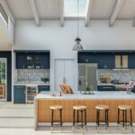 a-large-kitchen-with-a-center-island-surrounded-by-stools