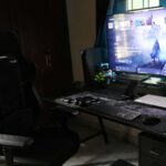 a-computer-desk-with-a-large-monitor-and-keyboard